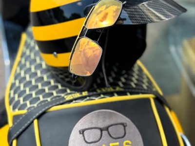 Sunglasses from EYES on St Albans sitting on the back of Jez's vespa bike - all branded in black, yellow and EYES on St Albans logos