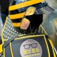 Sunglasses from EYES on St Albans sitting on the back of Jez's vespa bike - all branded in black, yellow and EYES on St Albans logos
